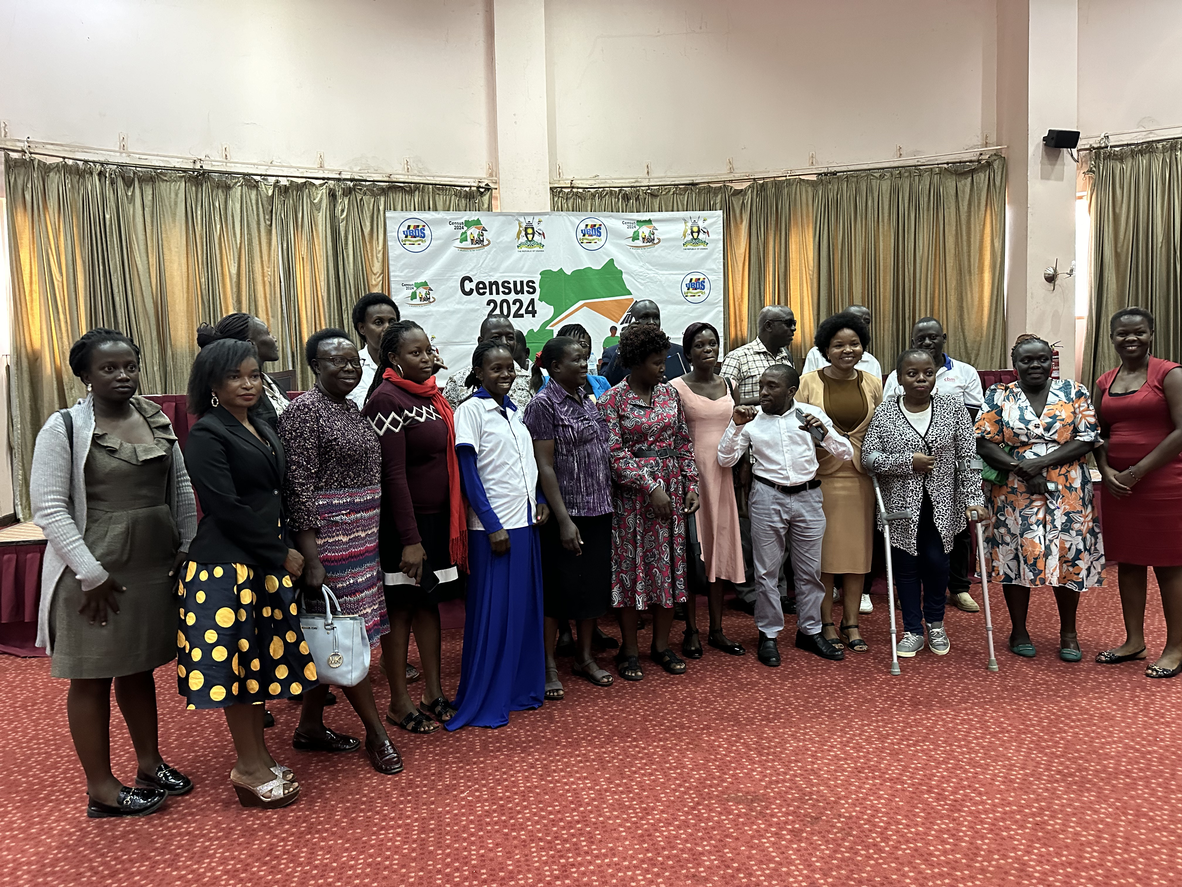 A group photo of persons with and without disabilities representing organisations of persons with disabilities and the Council at UBOS breakfast meeting