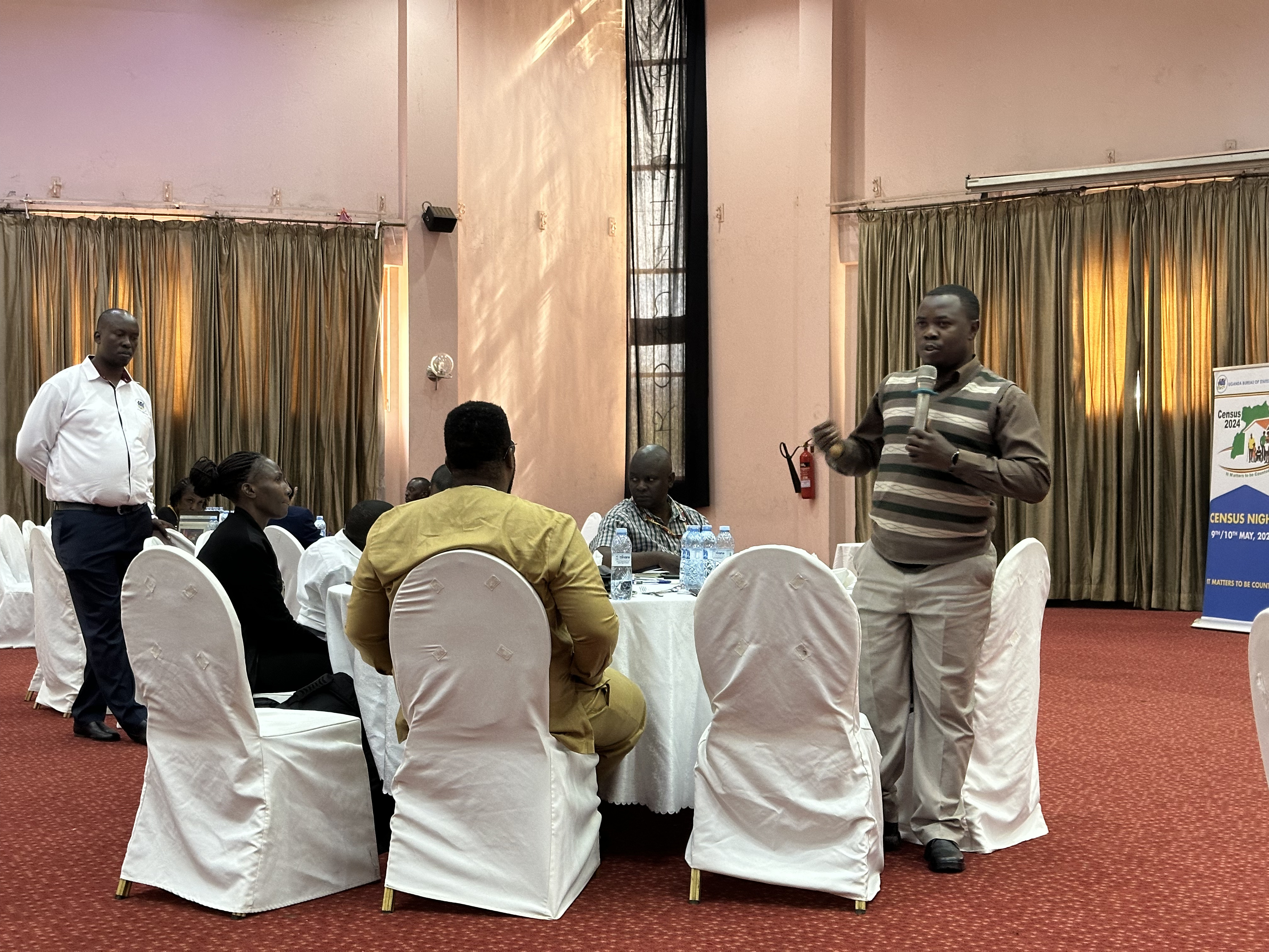 A black man with a disability addressing the crowd in a meeting